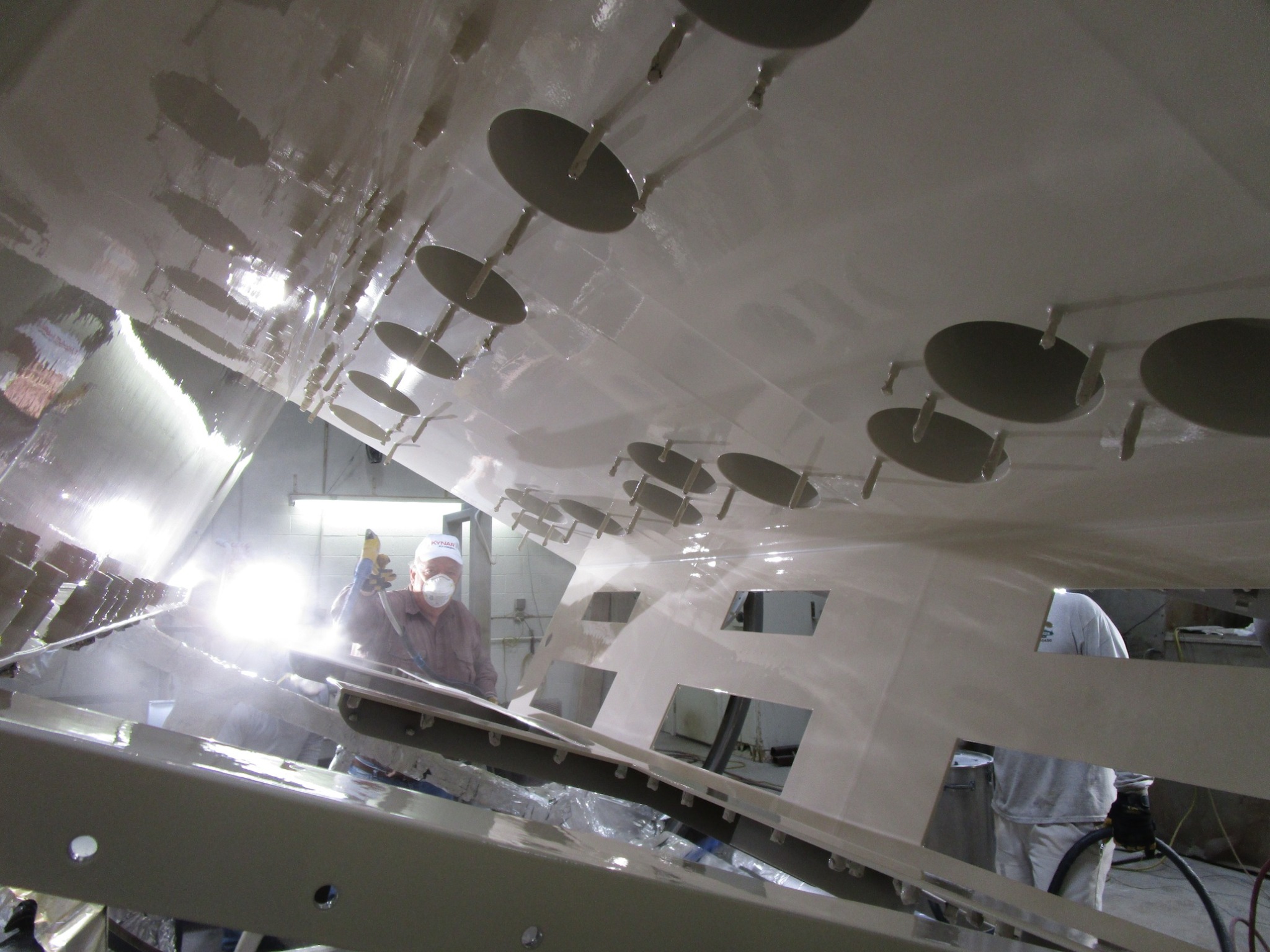 Fisher Company technician applying a coating inside industrial equipment